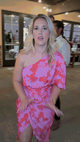 a woman in a pink and red dress dancing