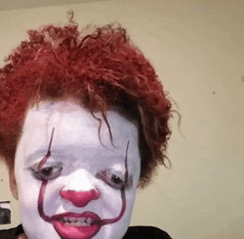 a close up of a person wearing a clown costume .