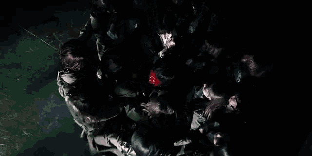 a group of people are laying in a circle with their hands up