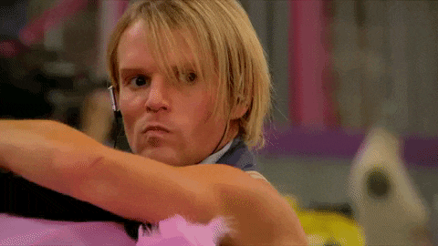 a man with blonde hair is wearing a headset and making a face