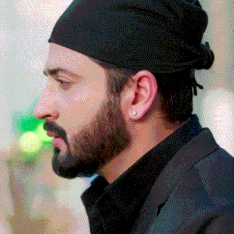 a man with a beard wearing a black hat