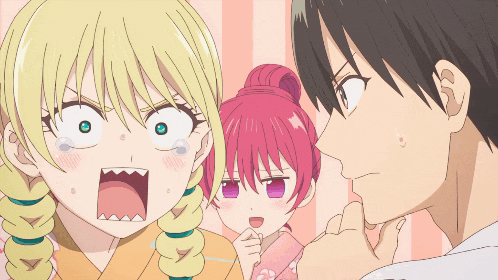 a man and two girls are looking at each other with one girl making a funny face
