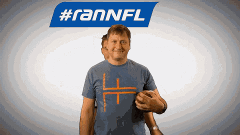 a man in a blue shirt holds a football in front of a #rannfl logo