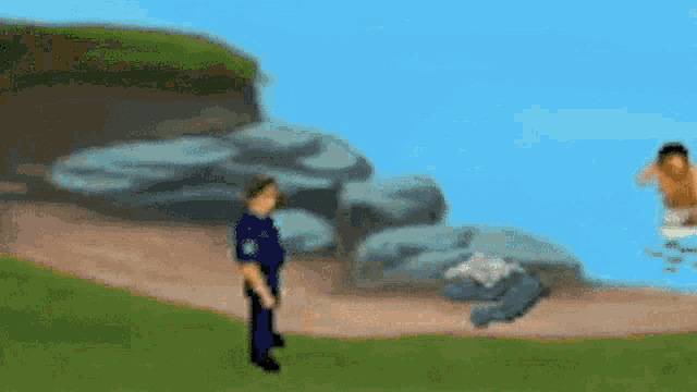 a blurry picture of a police officer standing next to a man swimming in the ocean .