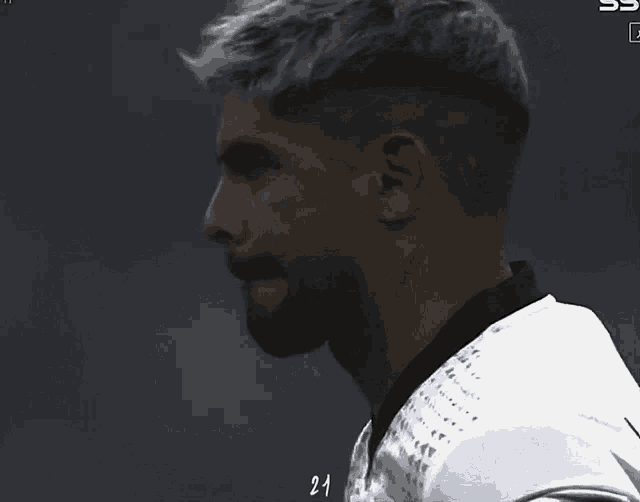 a close up of a man 's face with the number 21 on his shirt