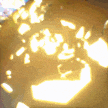 a blurred image of a yellow background with a few white spots