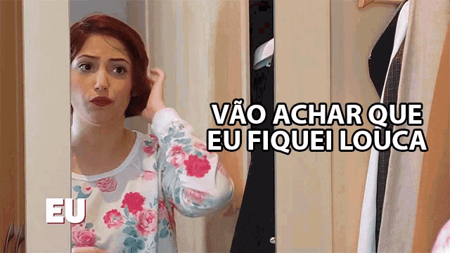 a woman in a floral shirt is looking at herself in a mirror and the words eu are above her