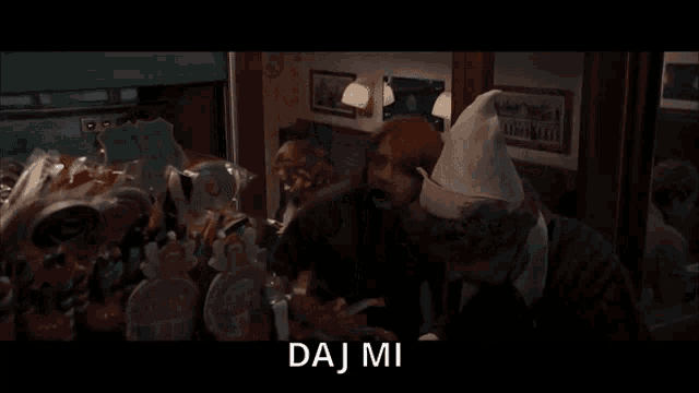 a man in a white hat talks to another man with the word okenu on the bottom right