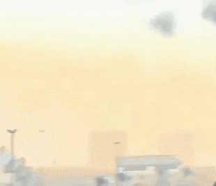 a robot is flying in the air with a yellow light on its head .