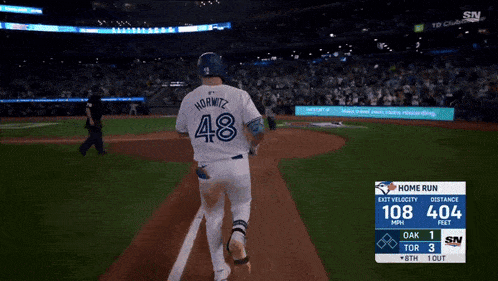 a baseball game is being played with a scoreboard showing that adams is up to bat