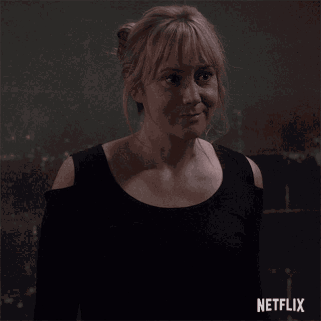 a woman in a black top with netflix written on the bottom