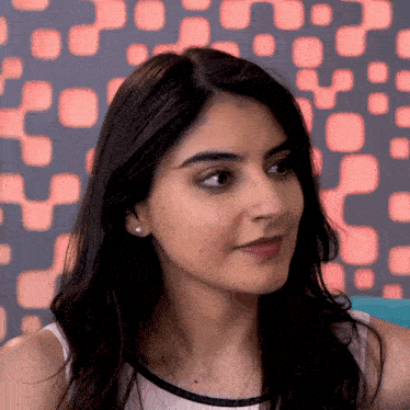 a close up of a woman 's face with a geometric pattern in the background