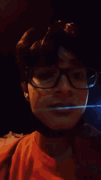 a close up of a person 's face with glasses on