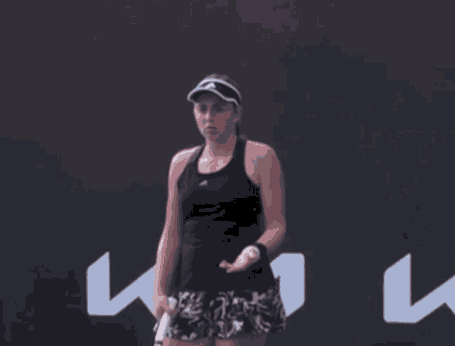 a woman is holding a tennis racquet in front of a sign that says ' kiwi '