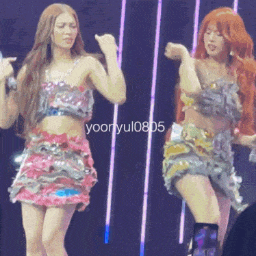 two women dancing on a stage with the number yooryul0805