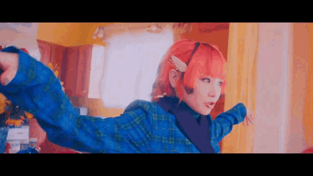 a girl with red hair is wearing a blue plaid jacket and a pearl hair clip .