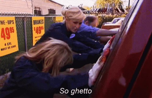 a group of people are working on a red car and one of them is saying " so ghetto "