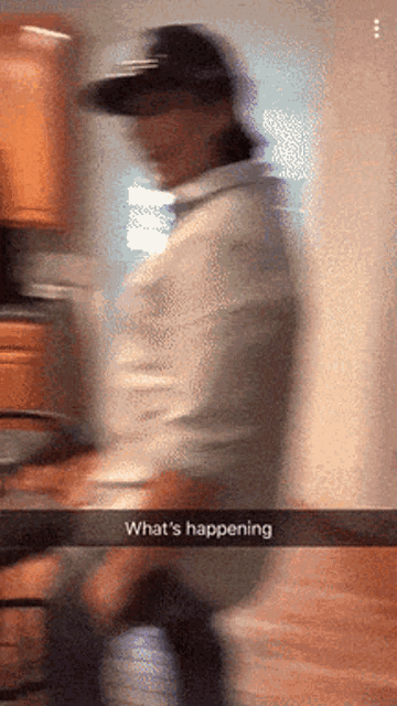 a blurred image of a person with the words what 's happening below them