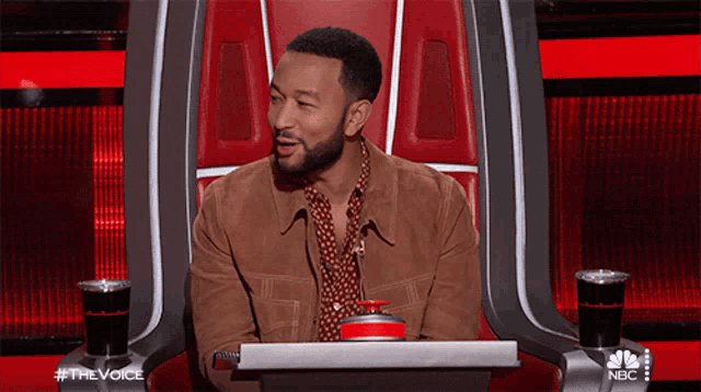 a man sits in a chair with a nbc logo on the bottom