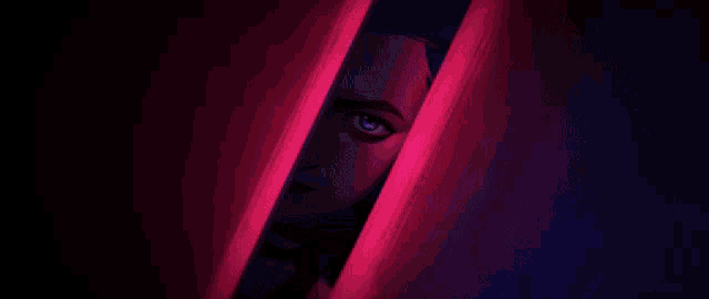 a close up of a woman 's face peeking out from behind a wall in a dark room .