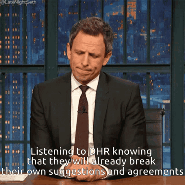 a man in a suit and tie is listening to dhr knowing that they already break their own suggestions and agreements