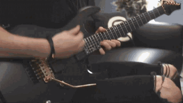 a man is playing an electric guitar with a yamaha logo on the back