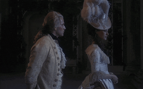 a man and a woman are standing next to each other