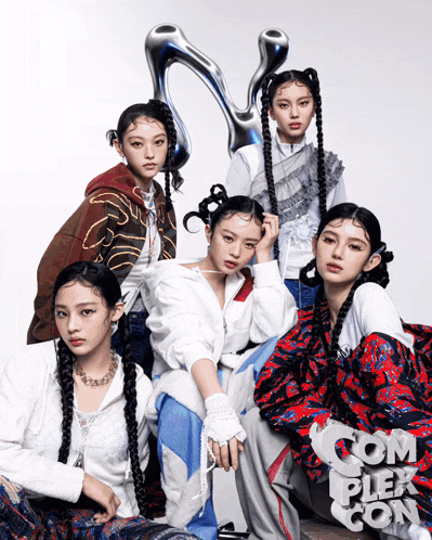 a group of young women are posing for a photo with the word complex on the bottom right
