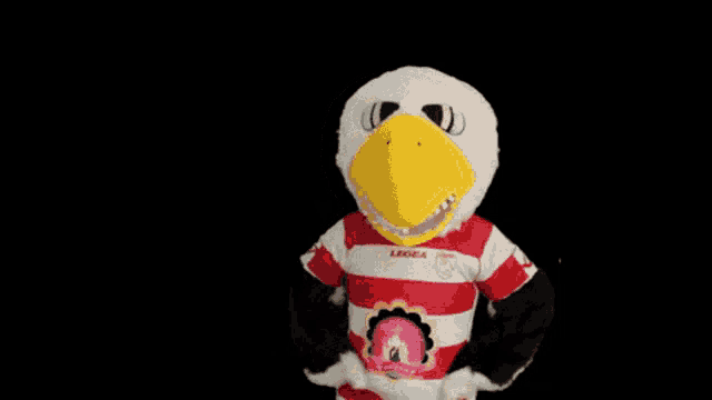 a mascot wearing a red and white striped legea shirt
