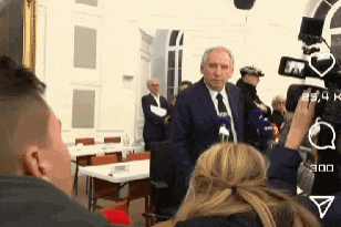a man in a suit and tie is being interviewed