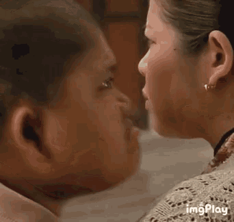 a close up of two people kissing with the words imgplay visible in the corner