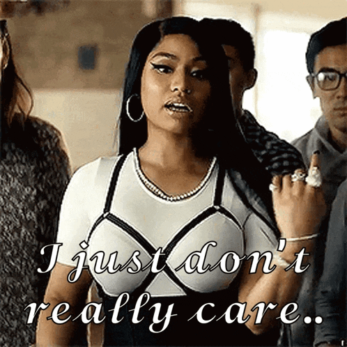 a woman is standing in front of a group of people and says " i just don 't really care " .