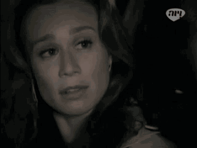 a woman is crying in a foreign language with a heart in the corner