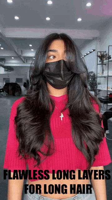 a woman with long hair wearing a mask and a red shirt