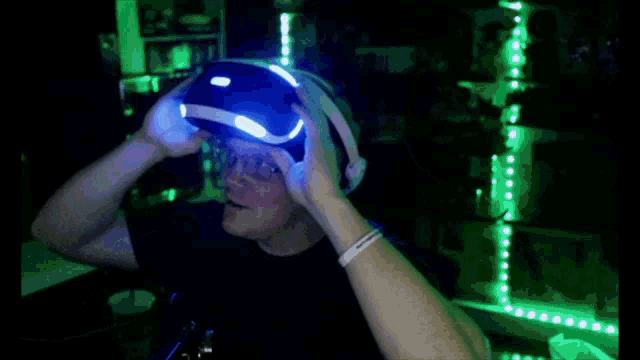 a man wearing glasses and a virtual reality headset looks at the camera