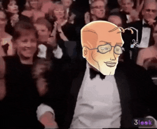 a man in a tuxedo and bow tie is clapping in front of a crowd .