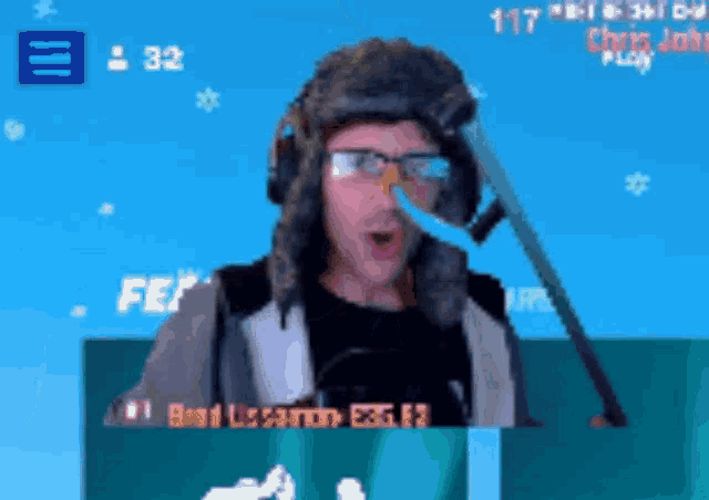 a man wearing a fur hat and glasses is playing a game