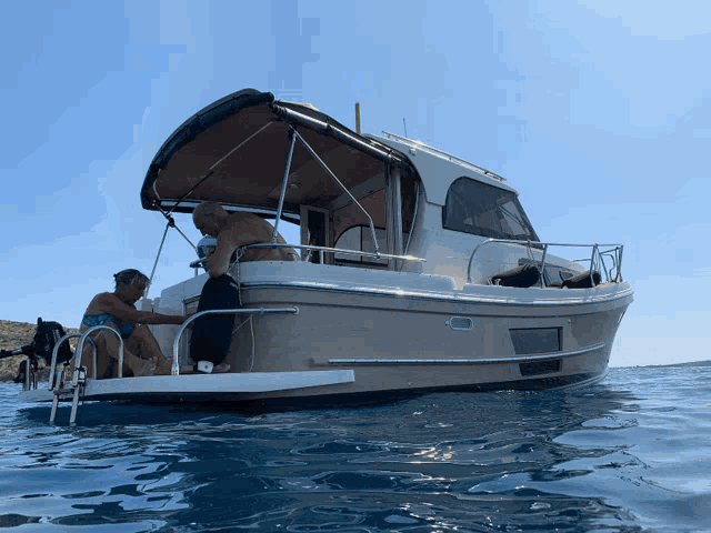a man sits on the back of a boat