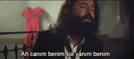 a man with a beard wearing a suit and tie says ah canim benim sol yanim benim