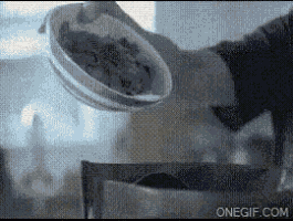 a gif of a person pouring food into a pot with the website onegif.com visible in the corner