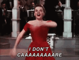 a woman in a red dress says " i don 't caaaaaare "
