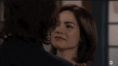 a man and woman are hugging each other in a room .