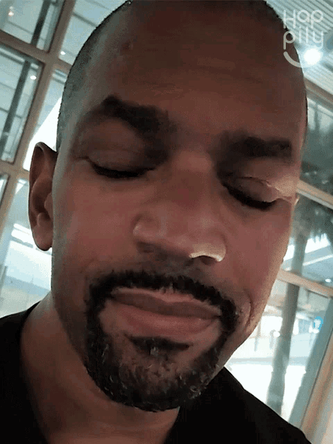 a close up of a man 's face with the word hop on the bottom left