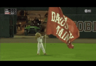 a mascot holding a flag that says dags min