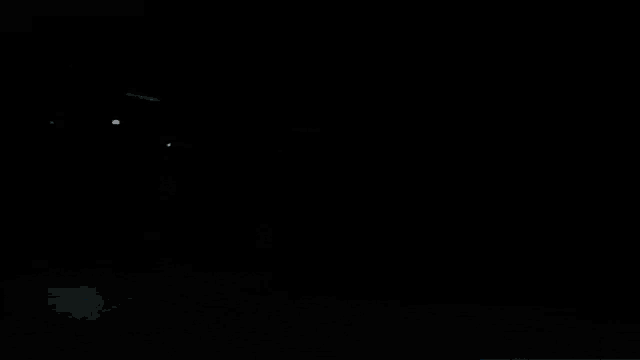 a stage with a lot of lights and smoke coming out of it at night