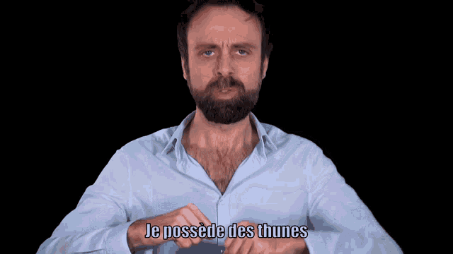 a man with a beard is making a funny face and the word quais is on the bottom of his face