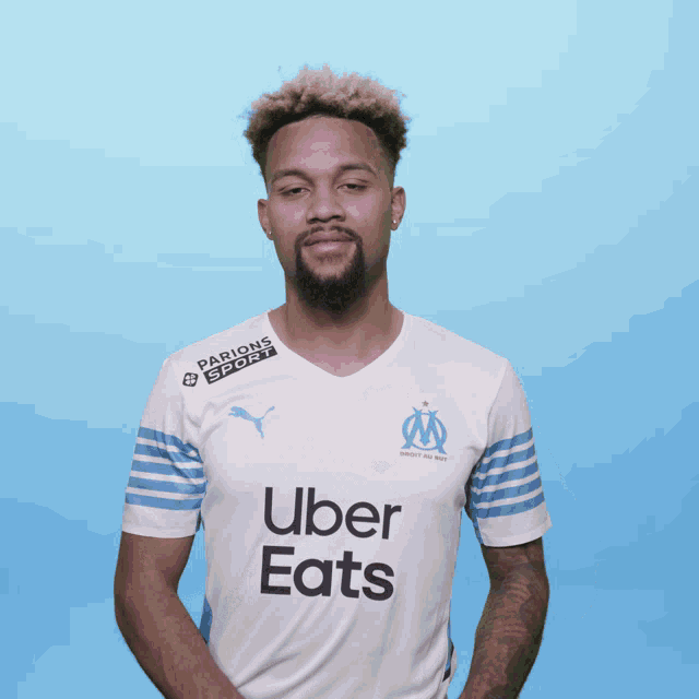 a man wearing a white uber eats shirt