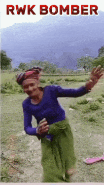 a woman is dancing in a field with rwk bomber written on the top