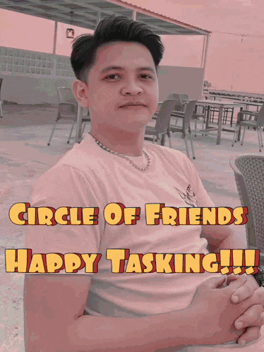 a man sits in front of a sign that says " circle of friends happy tasking "