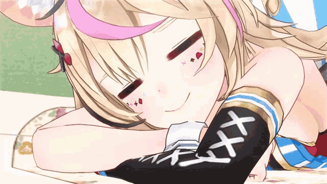 a close up of a girl laying down with a black sleeve with x on it